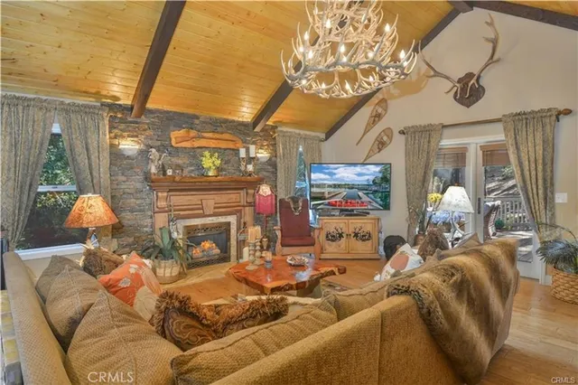 a living room with fireplace furniture and a flat screen tv