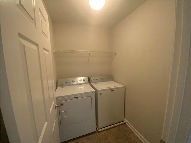 an empty room with a window and a mirror