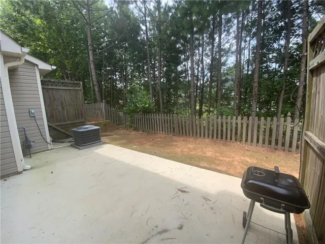 a view of a backyard with fence