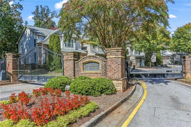 a house with lots of trees in the background