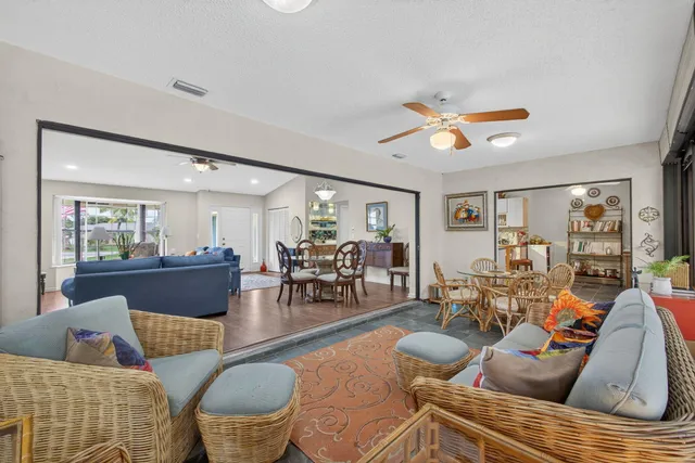 a living room with fireplace furniture and a large window