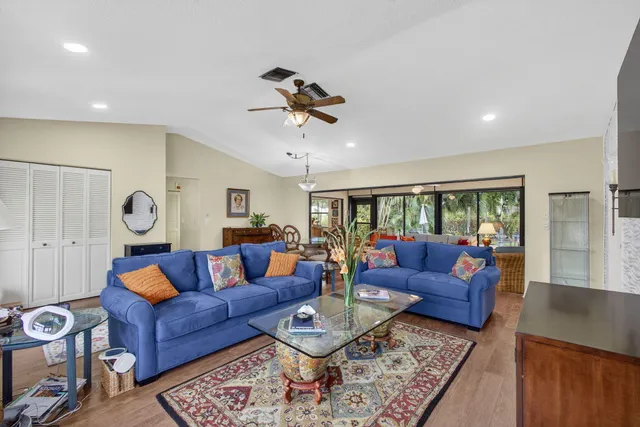 a living room with furniture ceiling fan and a rug