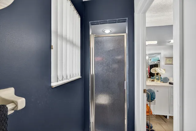 a bathroom with a sink vanity mirror bathtub and toilet