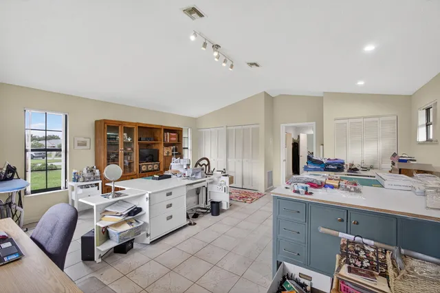 a view of a swimming pool with a patio and a garden