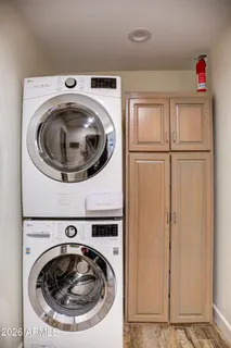 a kitchen with stainless steel appliances kitchen island granite countertop a stove a sink dishwasher a refrigerator and a dining table with wooden floor