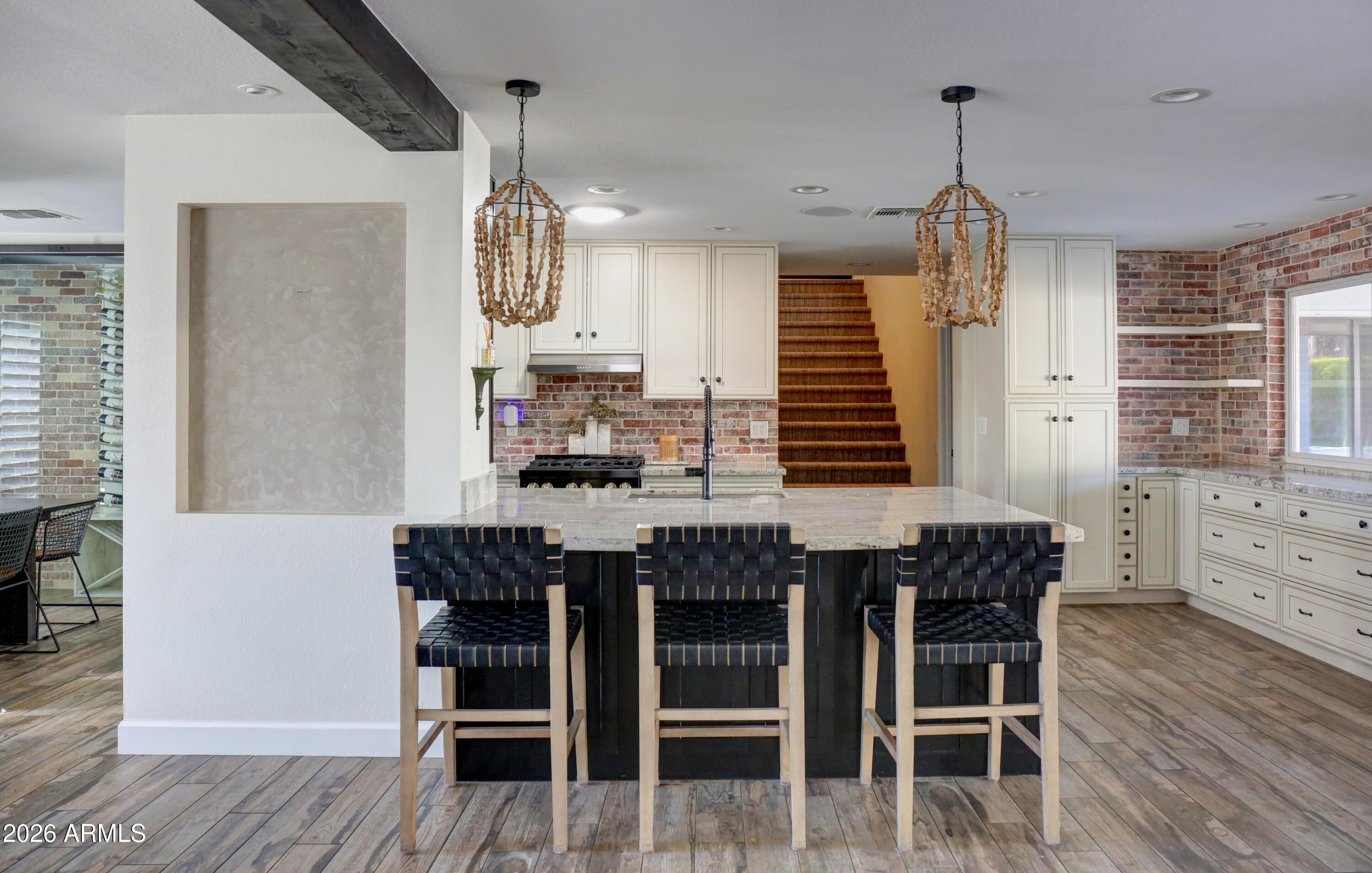2016 East State Avenue Phoenix, AZ 85020 - Photo 41 of 42 a kitchen with granite countertop a table chairs wooden floors and a view of living room