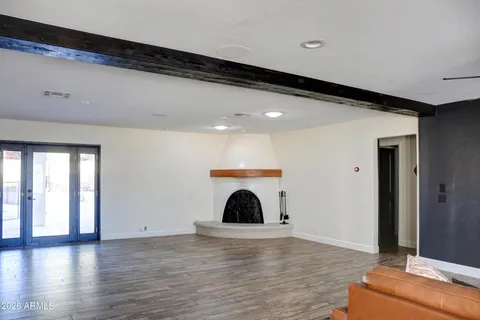 a kitchen with stainless steel appliances kitchen island granite countertop a table chairs sink refrigerator and cabinets