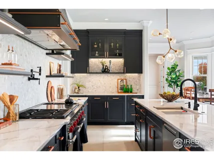 a kitchen with kitchen island granite countertop a sink counter top space and stainless steel appliances