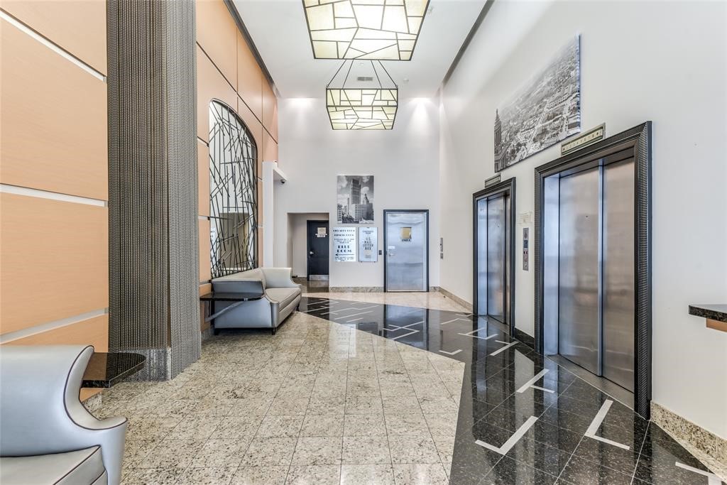 705 Main Street, Unit 315 Houston, TX 77002 - Photo 15 of 16 a living room with furniture chandelier and a large window