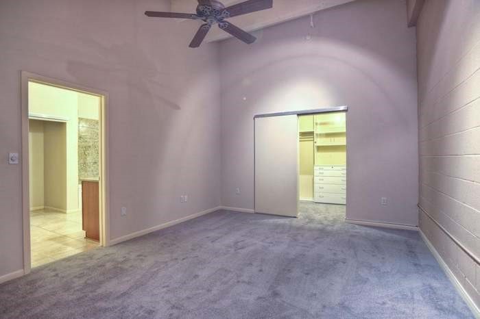 705 Main Street, Unit 315 Houston, TX 77002 - Photo 5 of 16 an empty room with a window and a ceiling fan