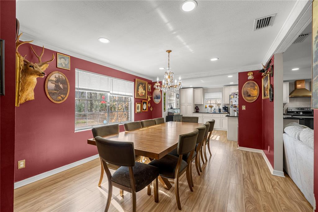 5100 Southeast 44th Avenue Road Ocala, FL 34480 - Photo 17 of 41 a dining room with furniture and wooden floor