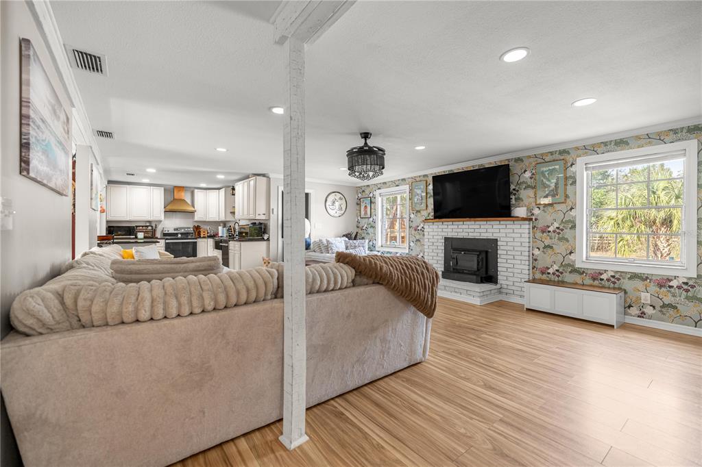 5100 Southeast 44th Avenue Road Ocala, FL 34480 - Photo 19 of 41 a living room with furniture a fireplace and a flat screen tv