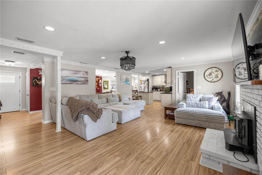 5100 Southeast 44th Avenue Road Ocala, FL 34480 - Photo 20 of 41 a living room with fireplace furniture and wooden floor