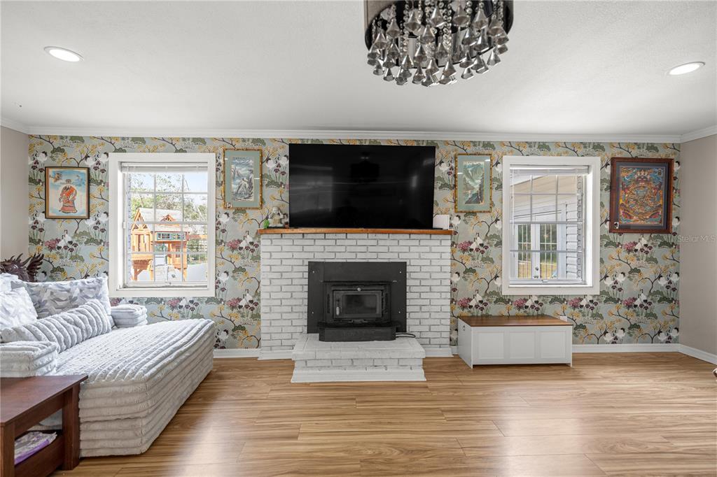 5100 Southeast 44th Avenue Road Ocala, FL 34480 - Photo 21 of 41 a living room with furniture a flat screen tv and a fireplace