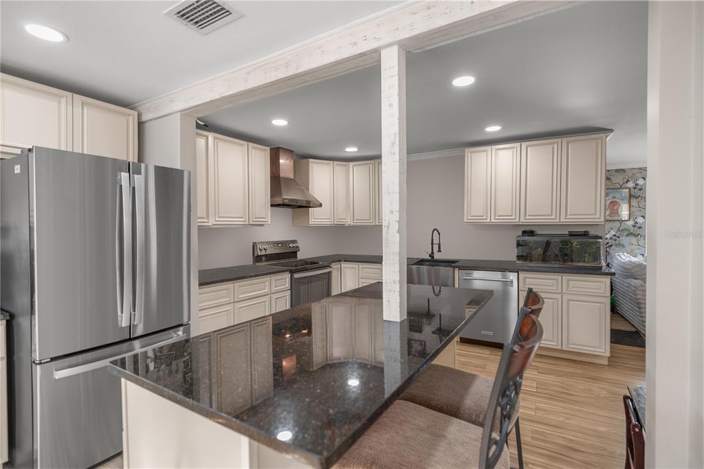 5100 Southeast 44th Avenue Road Ocala, FL 34480 - Photo 23 of 41 a kitchen with stainless steel appliances granite countertop a refrigerator sink and stove