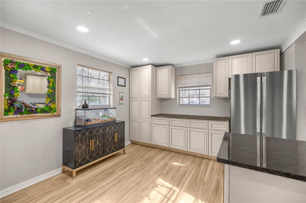 5100 Southeast 44th Avenue Road Ocala, FL 34480 - Photo 24 of 41 a kitchen with stainless steel appliances granite countertop a refrigerator a stove a sink and a microwave