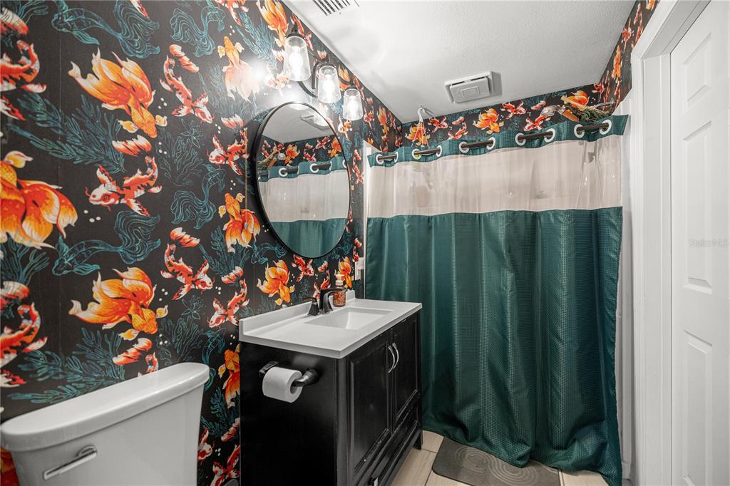 5100 Southeast 44th Avenue Road Ocala, FL 34480 - Photo 32 of 41 a bathroom with a sink mirror and vanity