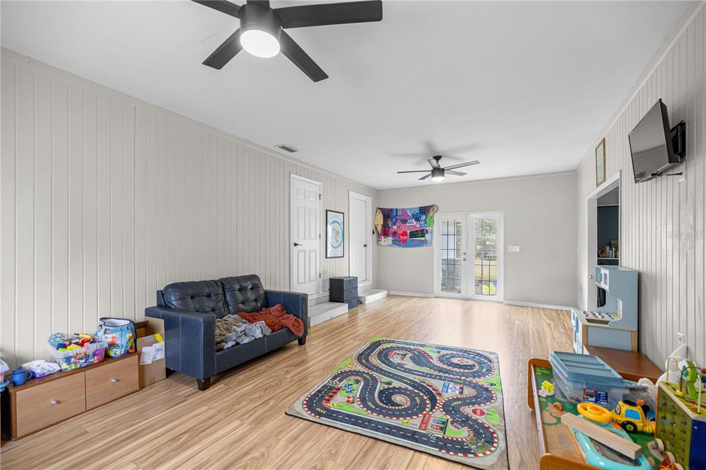 5100 Southeast 44th Avenue Road Ocala, FL 34480 - Photo 35 of 41 a living room with furniture and a flat screen tv