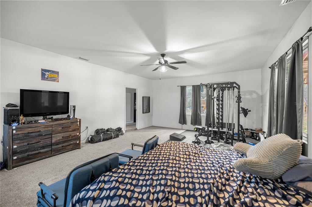 5100 Southeast 44th Avenue Road Ocala, FL 34480 - Photo 37 of 41 a bedroom with a bed and a flat screen tv