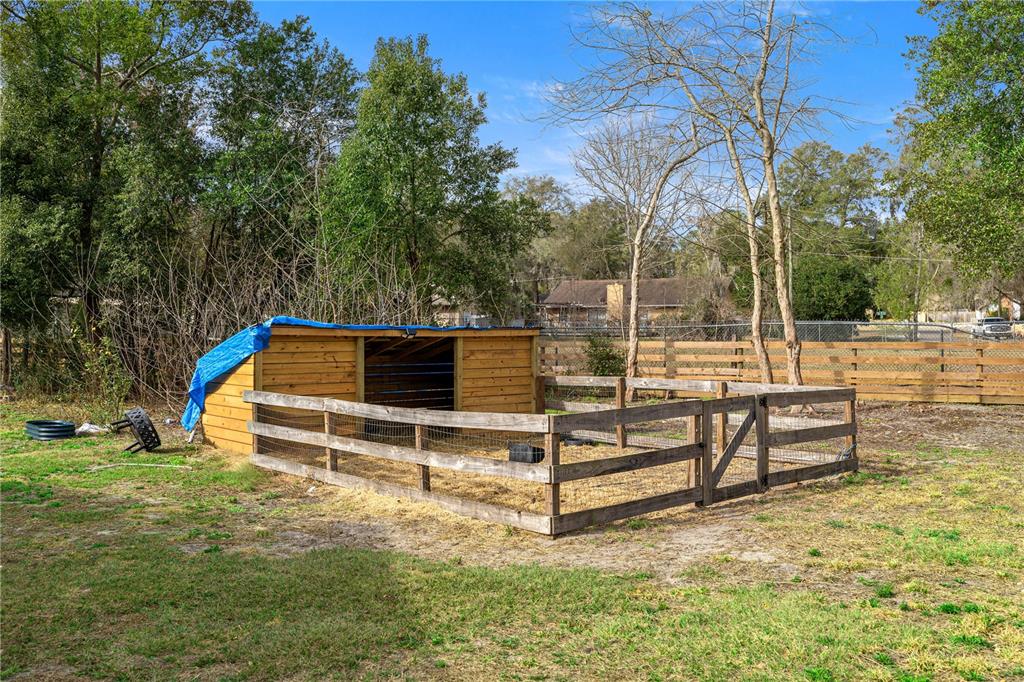 5100 Southeast 44th Avenue Road Ocala, FL 34480 - Photo 40 of 41 a view of backyard with wooden fence and a bench