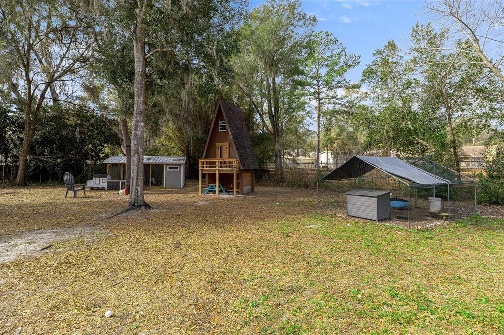 5100 Southeast 44th Avenue Road Ocala, FL 34480 - Photo 41 of 41 a front view of a house with a yard and garage