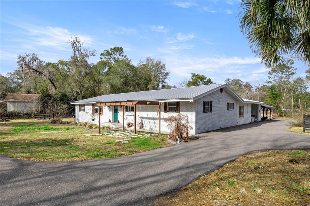 5100 Southeast 44th Avenue Road Ocala, FL 34480 - Photo 5 of 41 a front view of a house with a yard