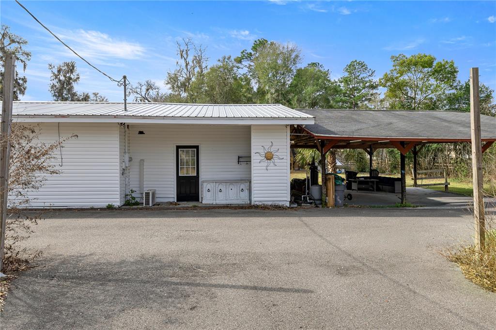 5100 Southeast 44th Avenue Road Ocala, FL 34480 - Photo 9 of 41 a view of a patio with table and chairs with wooden floor and fence