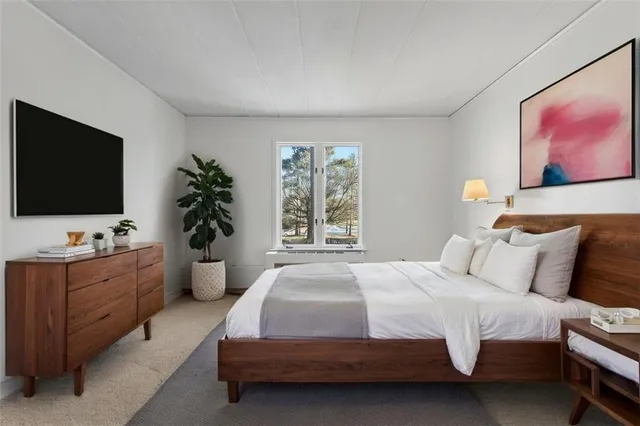 a bedroom with a large bed and a flat screen tv