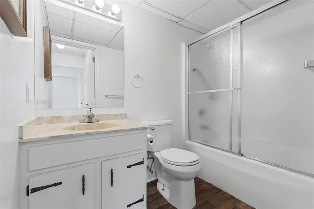 a bathroom with a toilet sink and shower