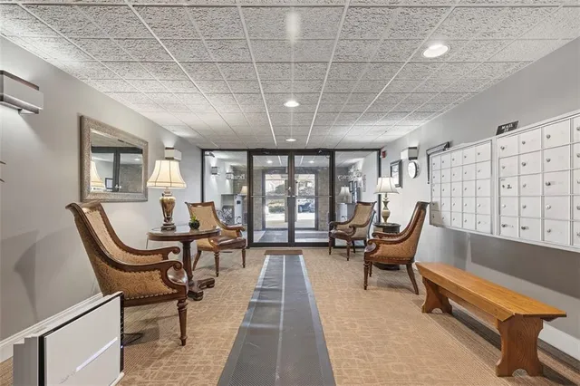 a very nice looking room with a large window and furniture