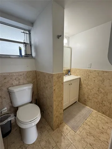 a bathroom with a sink a toilet and mirror