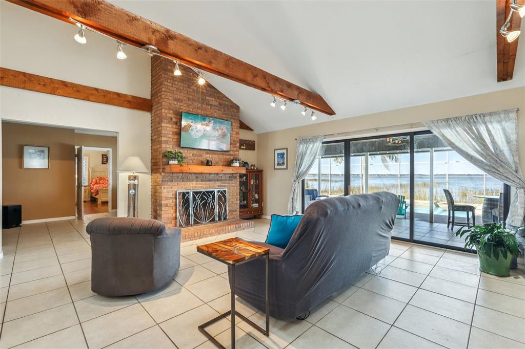 3050 Crump Road Winter Haven, FL 33881 - Photo 18 of 98 a living room with furniture a fireplace and a large window