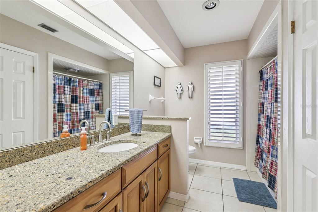 3050 Crump Road Winter Haven, FL 33881 - Photo 31 of 98 a bathroom with a granite countertop sink and a mirror