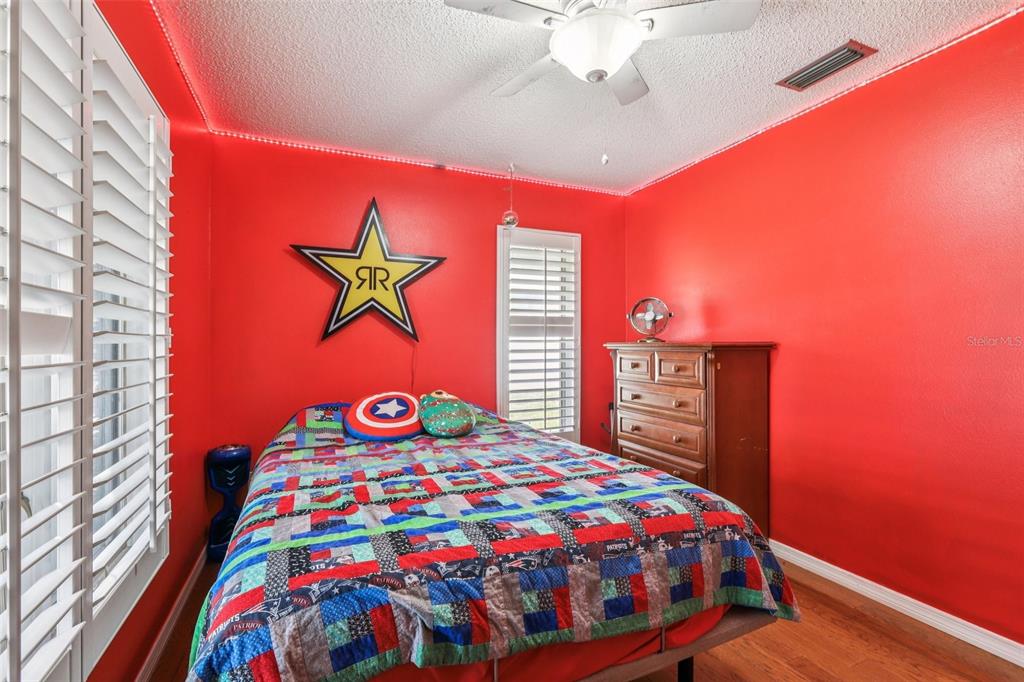 3050 Crump Road Winter Haven, FL 33881 - Photo 34 of 98 a bedroom with a bed and a chandelier