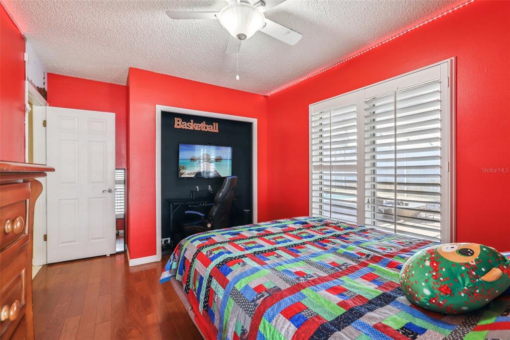 3050 Crump Road Winter Haven, FL 33881 - Photo 35 of 98 a bedroom with a bed and a chandelier