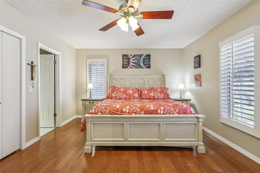 3050 Crump Road Winter Haven, FL 33881 - Photo 37 of 98 a bedroom with a bed and a chandelier fan