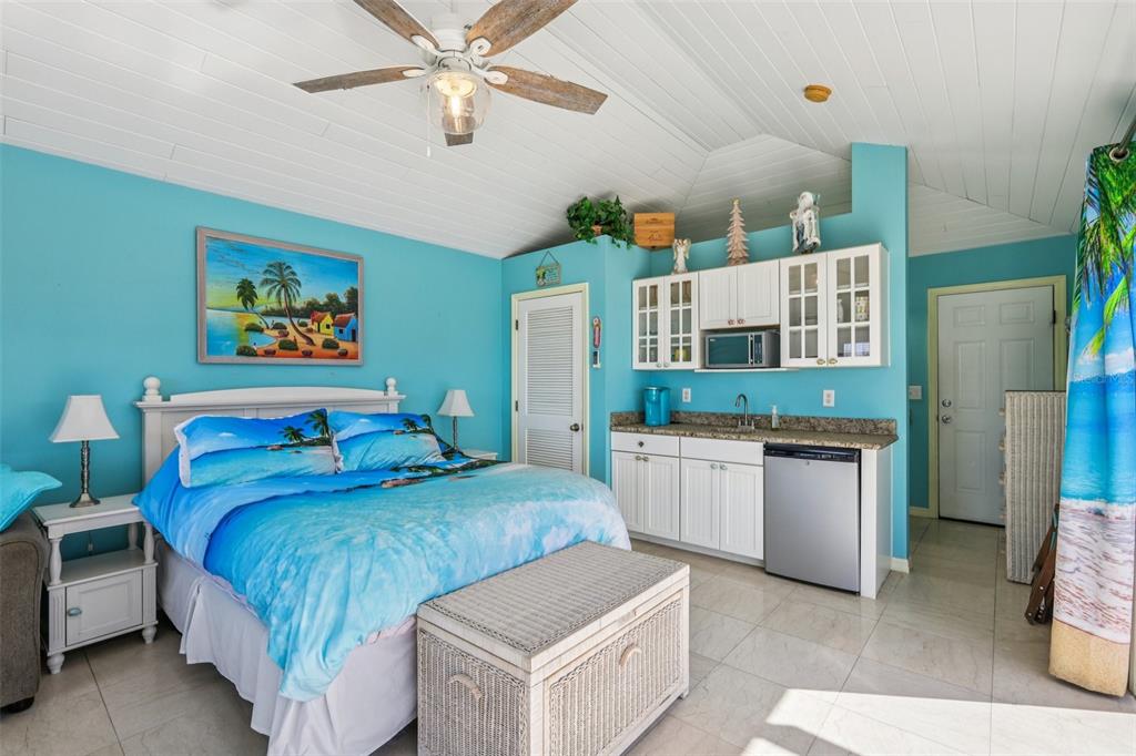 3050 Crump Road Winter Haven, FL 33881 - Photo 52 of 98 a spacious bedroom with a bed and a chandelier