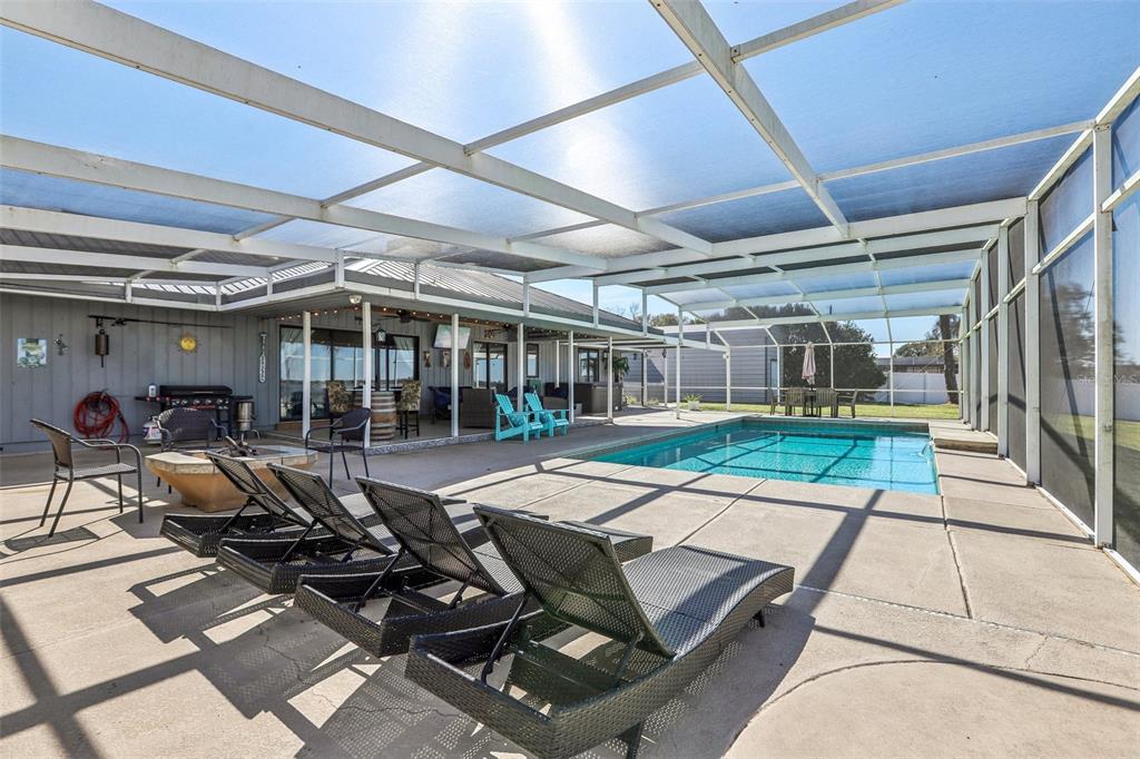3050 Crump Road Winter Haven, FL 33881 - Photo 67 of 98 a view of a patio with table and chairs and a barbeque