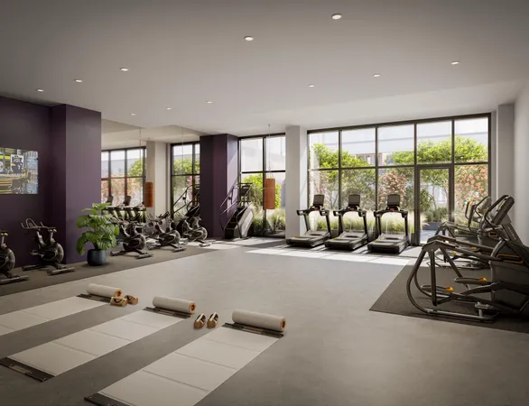 a view of a room with gym equipment and floor to ceiling window