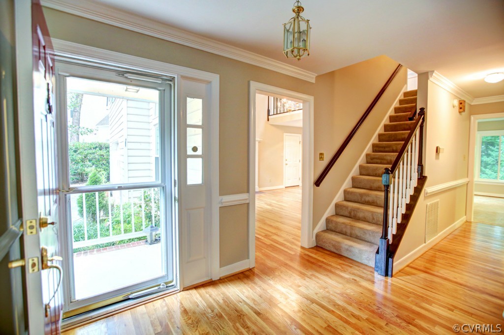 6001 Lansgate Road Midlothian, VA 23112 - Photo 4 of 24 a view of a hallway with wooden floor and windows