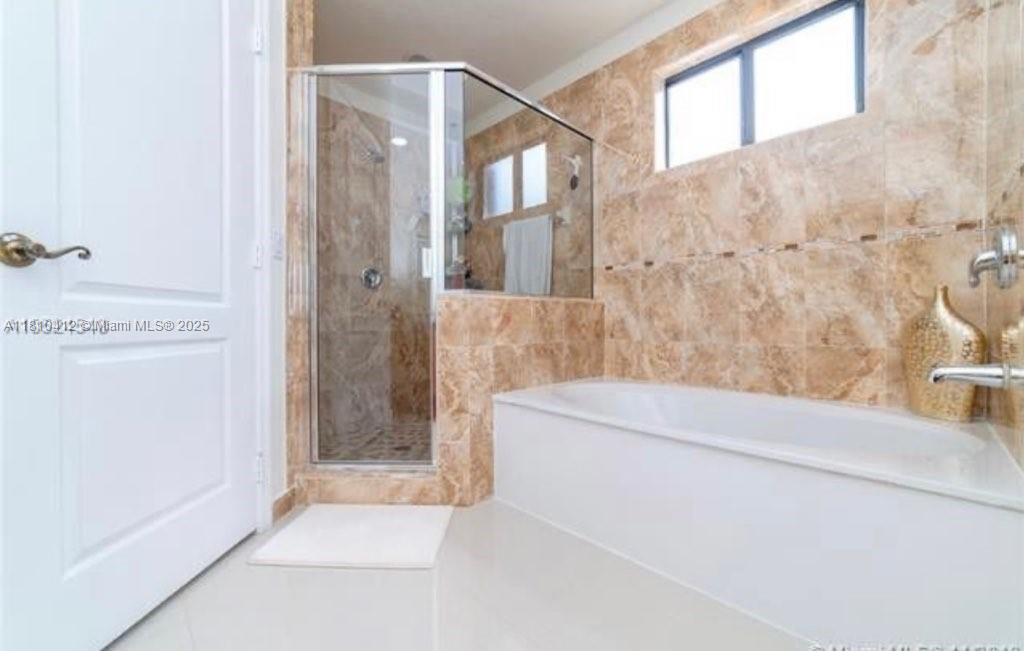 16588 Southwest 44th Street Miami, FL 33185 - Photo 13 of 14 a bathroom with a bathtub and shower