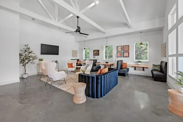 a living room with furniture a chandelier and a floor to ceiling window