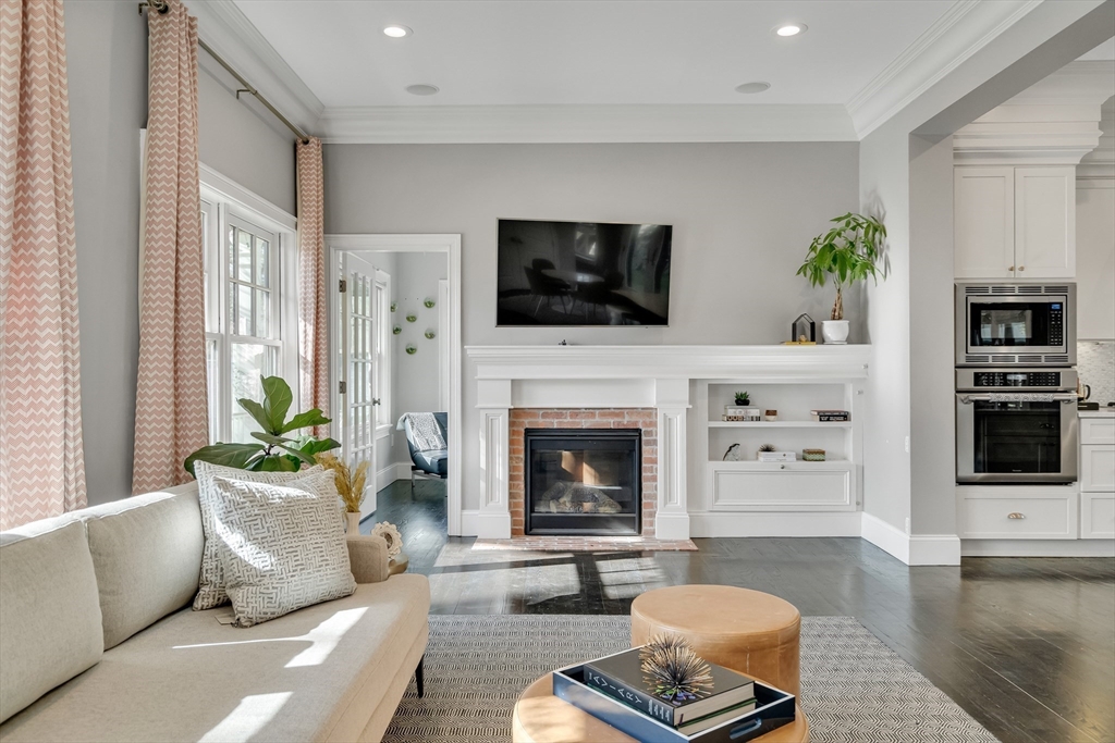 80 Buckman Drive Lexington, MA 02421 - Photo 4 of 29 a living room with furniture a flat screen tv and a fireplace