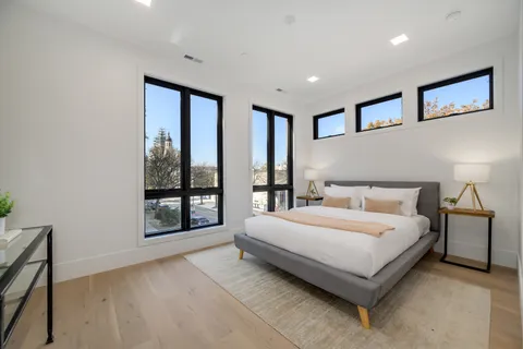 a bedroom with a large bed and a night stand