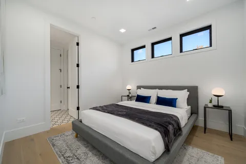 a bedroom with bed and a night stand