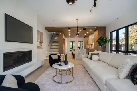 a living room with furniture a fireplace and a flat screen tv