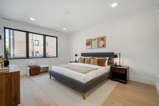 a bedroom with a large bed and a large window