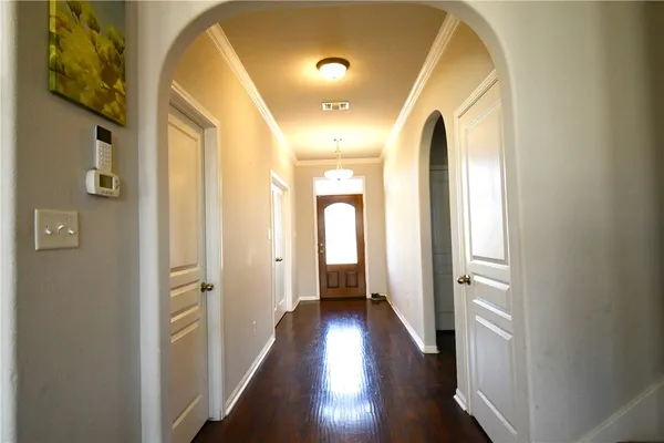 a view of a hallway with wooden floor