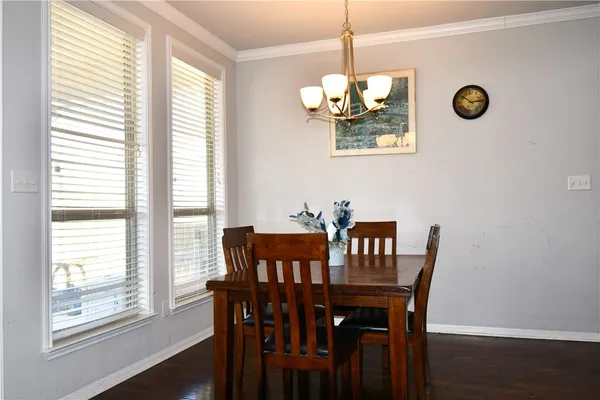 a view of a dining room with furniture wooden floor and chandelier