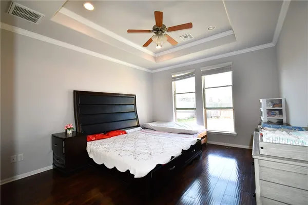 a bed room with a bed window and a television